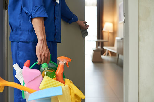unrecognizable-cleaner-walking-into-hotel-room-with-tools-and-detergents.jpg