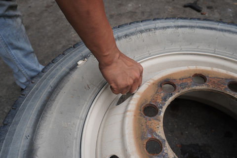 Man removing rim from truck tyre 
