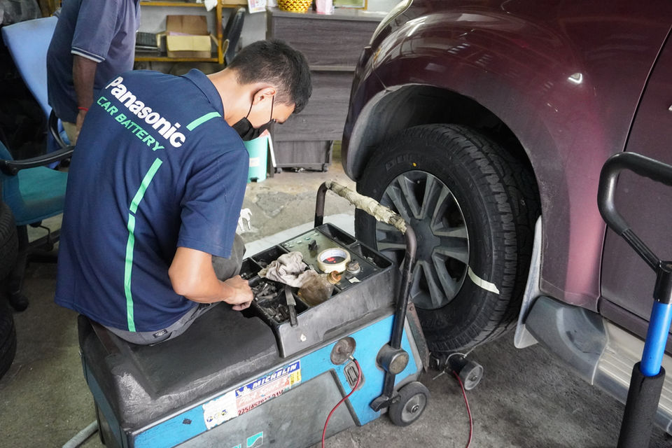 Man looking for tools to perform tyre balancing on a SUV