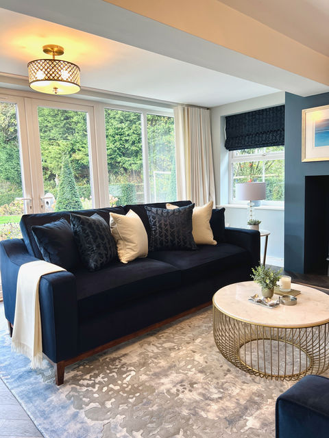 A view a beautiful bespoke sofa in our Bubwith lounge and entertaining rooms project. Part of a pair, set onto a plush textured rug, with bespoke made cushions. 