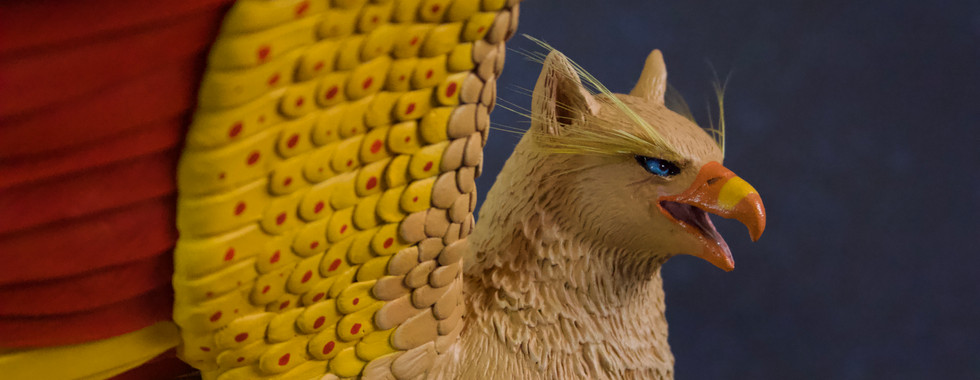 polymer clay sculpture of a griffin with open wings
