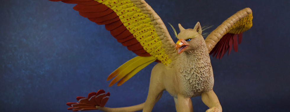 polymer clay sculpture of a griffin with open wings