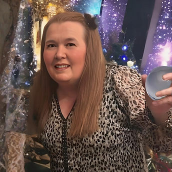 Woman smiling, holding a breast implant in her hand. Double Trouble At Home.