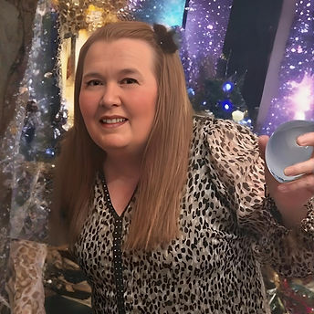 Woman smiling, holding a breast implant in her hand. Double Trouble At Home.