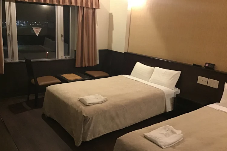 Twin guest room and beds at Hotel Gran View Okinawa