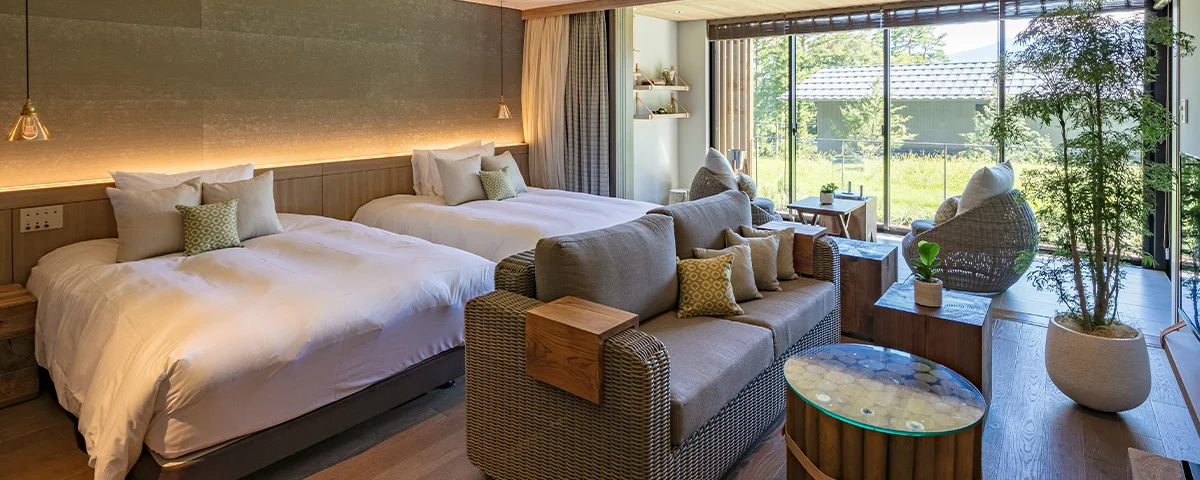 Twin beds and living space in a Komorebi Stylish Suite at FUFU Kawaguchiko
