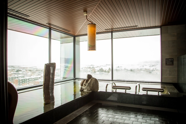 LA VISTA Furano Hills top-floor natural hot spring bath with Furano views
