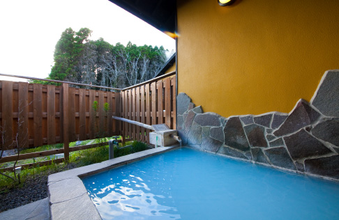 Private natural blue-spring bath and wooden terrace at Mori no Yu Yufuin Yasuha