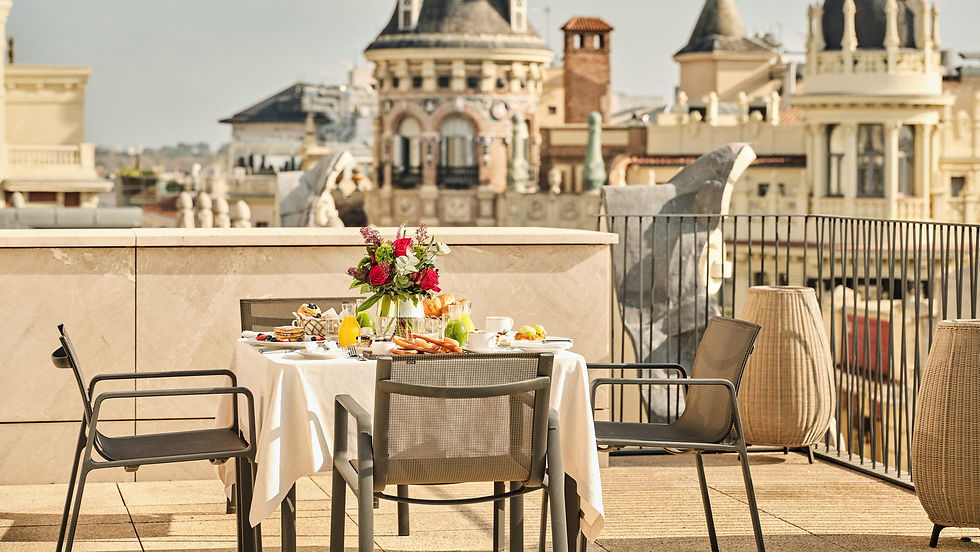 Rooftop table set for breakfast with flower arrangement