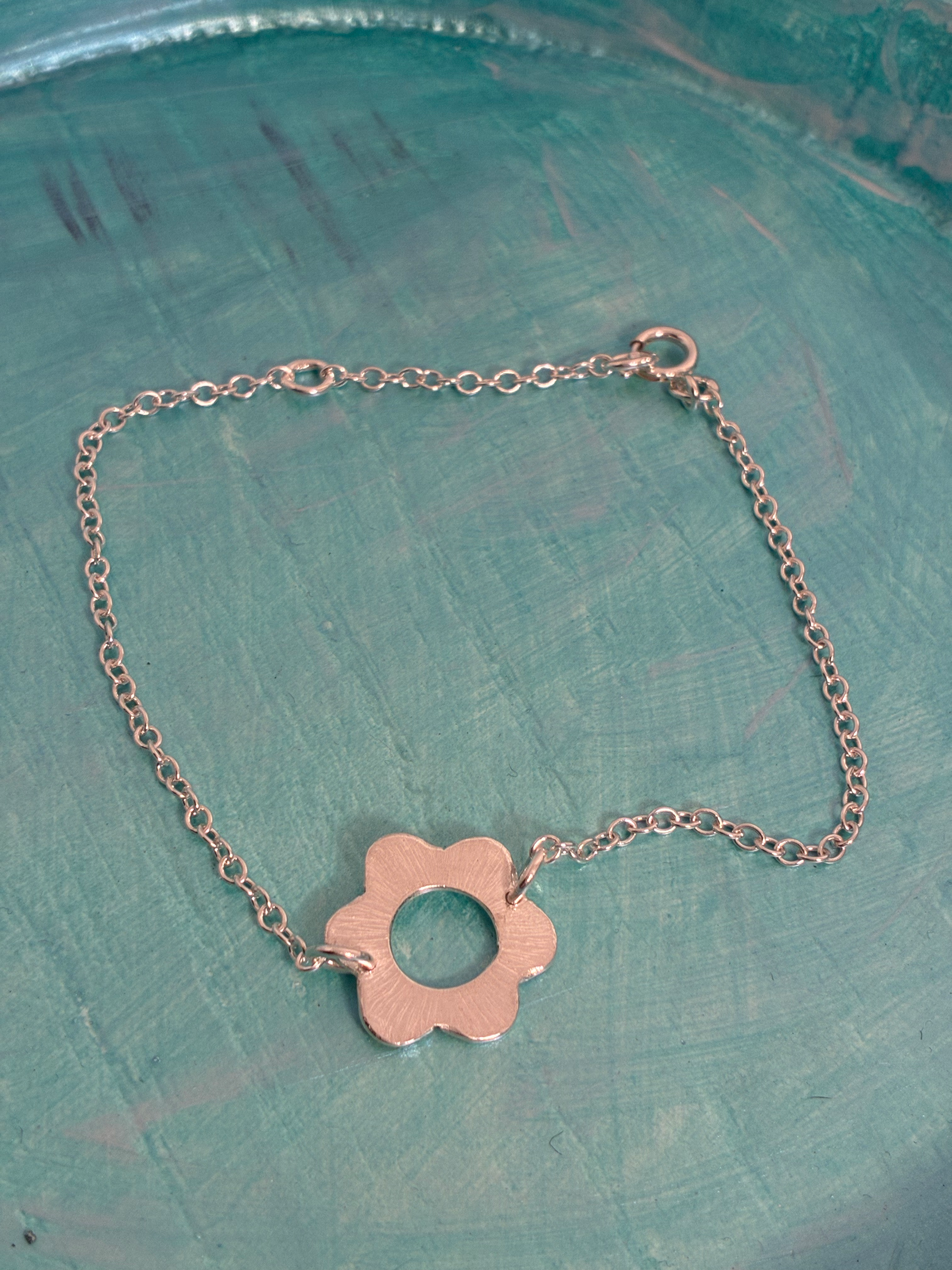 Sterling silver halo flower design bracelet. Can be set at 7 and 8 inch. 