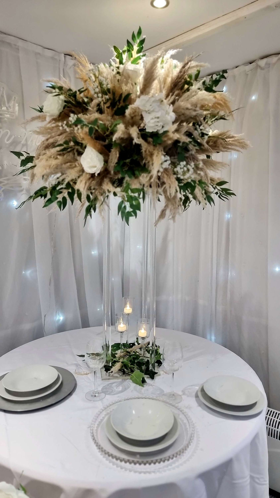Thumbnail: Pampas arrangements on colums with candles and garlands 