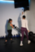 Close-up view of a personal trainer guiding a client during a workout
