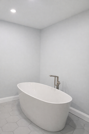 Spa-like master bathroom renovation in Easton with a double vanity and gold fixtures.