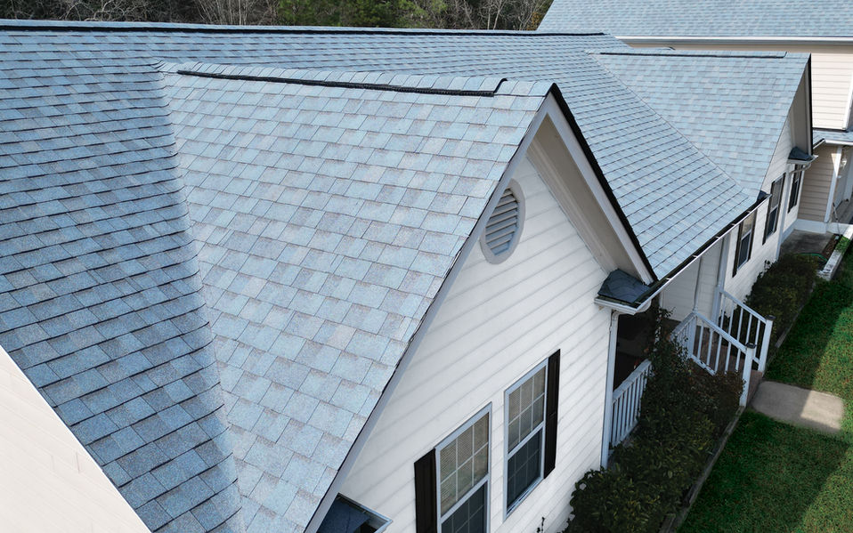 Aerial view of new architectural shingle roof replacement on a white home in Stevensville, MD