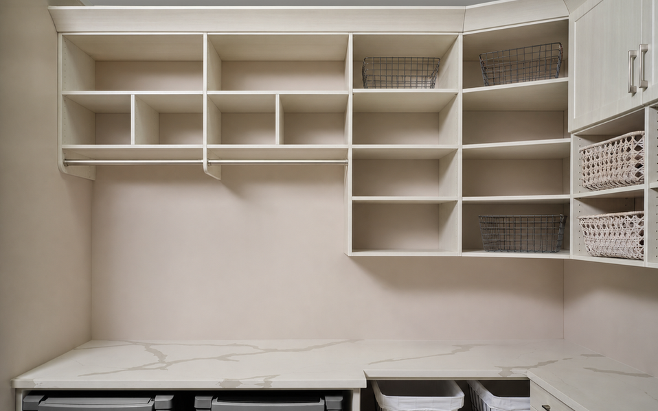 Custom white laundry room shelving and storage system in a Annapolis, MD home