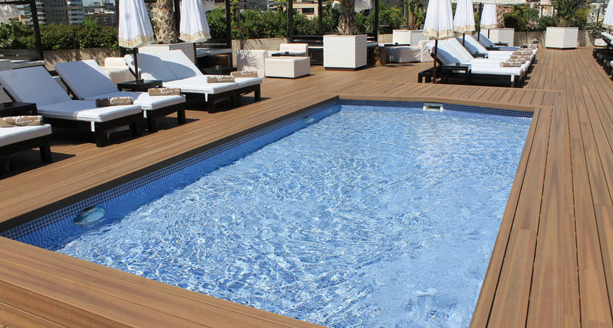 Brownstone composite decking around pool with lounge chairs