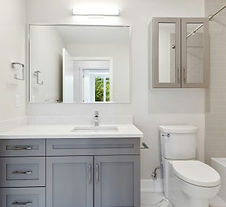 Luxury open-concept kitchen renovation in Annapolis, Anne Arundel County, featuring custom white cabinetry, marble waterfall island, and professional-grade stainless steel appliances.