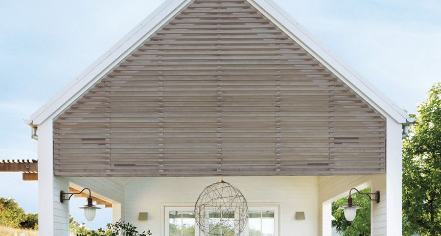 Shaded Grey composite deck under white outdoor pavilion with dining table