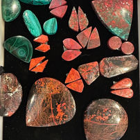 Polished green, red, and brown cabochon gemstones