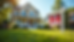 Eye-level view of a cozy suburban house with a "For Sale" sign in front