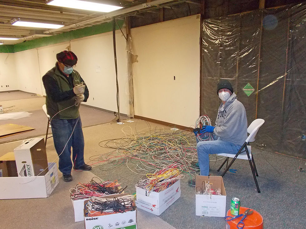 Volunteers bundle wiring at Great River Children's Museum