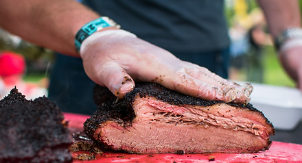 Contender cutting up a brisket of slow c