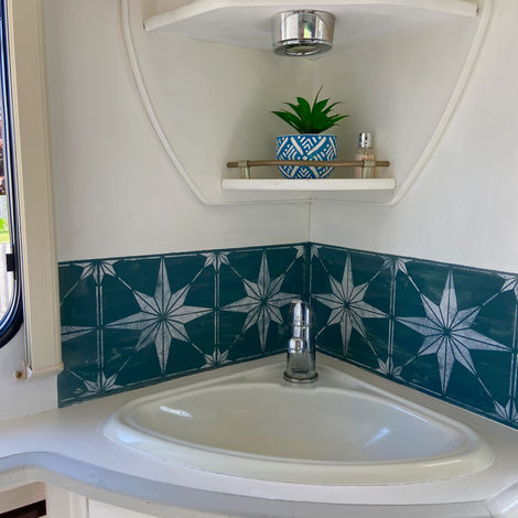 Hand painted tiles around caravan sink