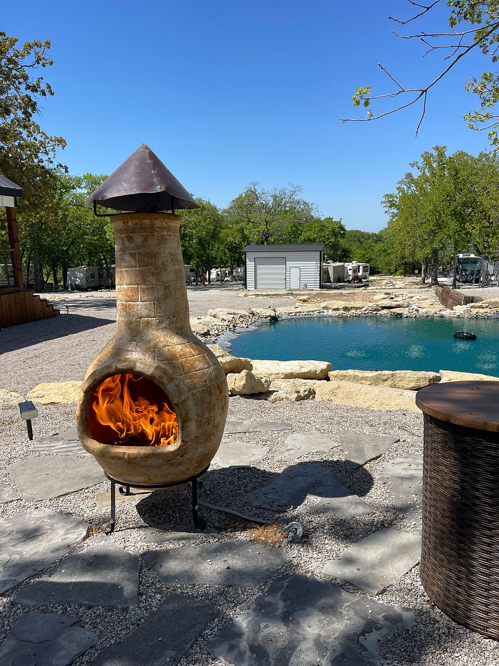 Wide angle view of a cabin porch with seating overlooking a forest