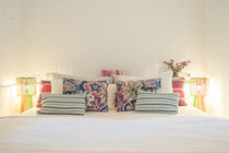 Bright double bedroom with colourful cushions in a Mallorca finca