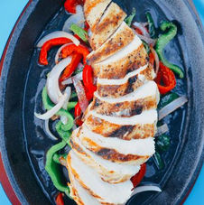 Grilled chicken and sautéed peppers served Tex-Mex style at Uno Mas - Tex-Mex Cantina in Dallas, TX.