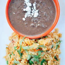 Traditional Mexican rice and seasoned beans served as a side dish at Uno Mas - Tex-Mex Cantina in Dallas, TX.