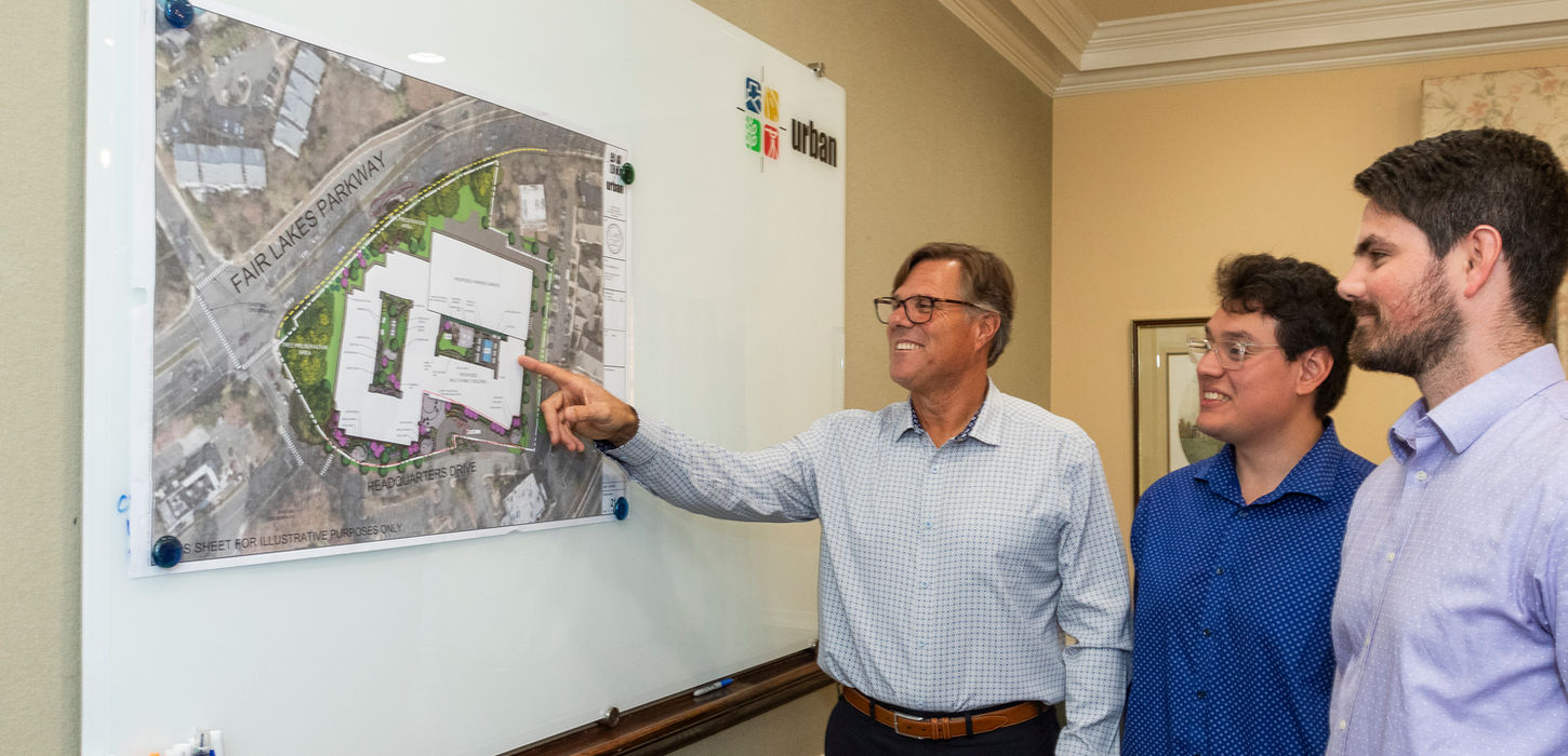 Urban Engineering staff coordinating project details for land development and engineering services in Virginia Maryland DC area