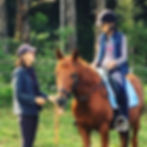 Riding instructor talking to a girl on a horse