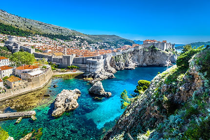 Cityscape on cliffs edge with blue Mediterranean sea
