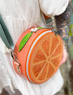 Handcrafted leather orange slice bag with hand painted details.