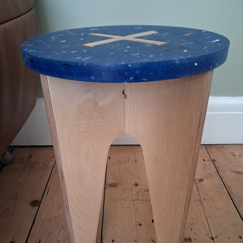 Product that can be used as a stool or side table made from plywood and  blue recycled plastic