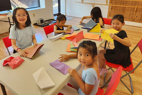 kids in a chinese culture camp cutting up paper