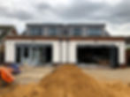 Happy homeowners receiving keys to their new self-build home