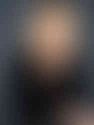 Portraits of a blonde woman in a v-neck black top playing with her hair and smiling at the camera | | luxury studio portrait session by Geni Bean Portraits in North Carolina