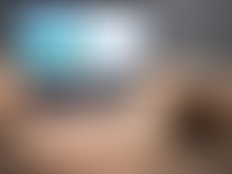 A cozy writing setup with a laptop displaying the cover and manuscript of “No Phones Allowed,” sitting on a cream knit blanket beside a steaming mug of tea in a quiet, blue-gray room.