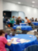 Group of people at painting event inside banquet hall