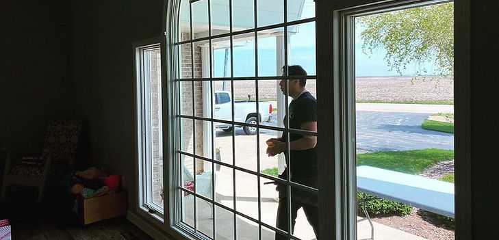 Residential privacy window film installed on arched gridded luxury window.