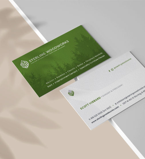 Business cards for cabinetry manufacturer placed on edge of table