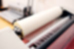 Lamination machine applying a protective finish to printed materials at Clinton Printing Co.