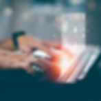 Hands typing on a laptop with a glowing digital interface overlay, symbolizing data management and system integration.