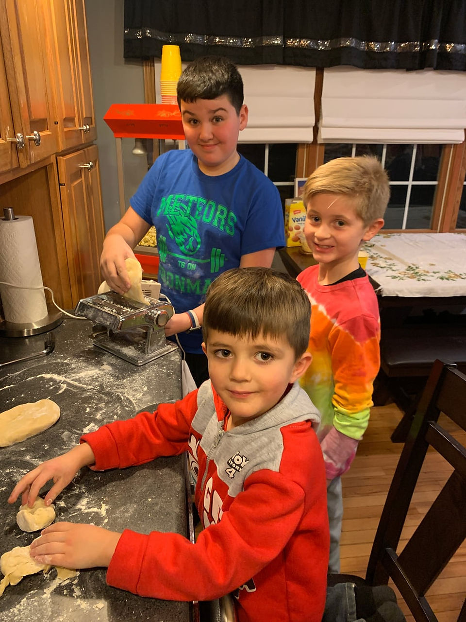 Kids making homemade ravioli during Thanksgiving.
