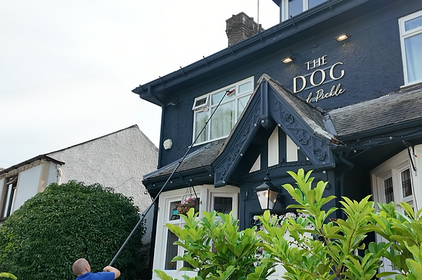 Cleaning large restaurant windows using water-fed brush pole