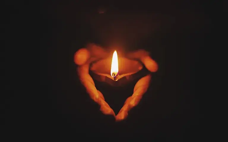 hands and candle.webp