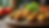 Eye-level view of a colorful vegan appetizer platter with stuffed mushrooms and falafel balls