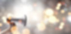 Person_Holding_Megaphone_Among_Lights.jp